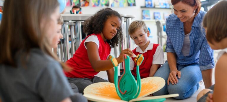 KS1 pupils exploring objects and talking about what they notice during a science lesson